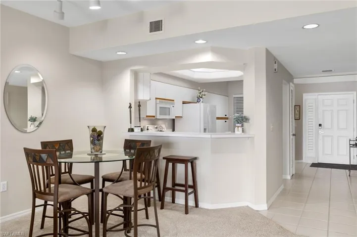 Dining area featuring light tile floors