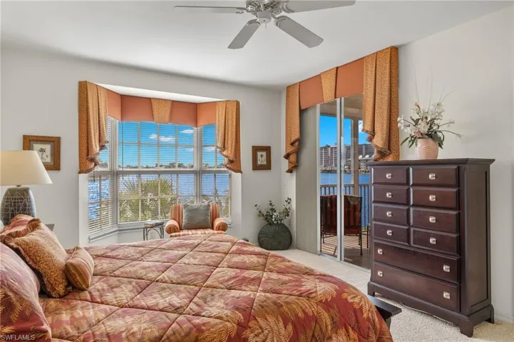 Bedroom featuring ceiling fan, light colored carpet, and access to outside