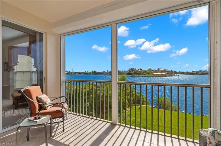 Sunroom / solarium featuring a water view