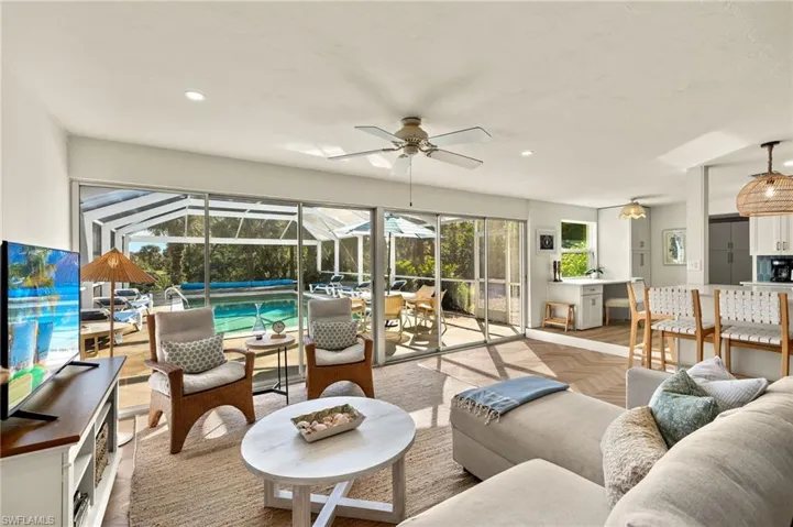 Sunroom featuring an outdoor hangout area, ceiling fan, and a patio