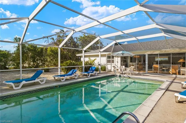 Outdoor pool with a sunroom, a lanai, and a patio area