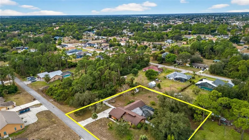 Aerial perspective of suburban area featuring property boundaries highlighted