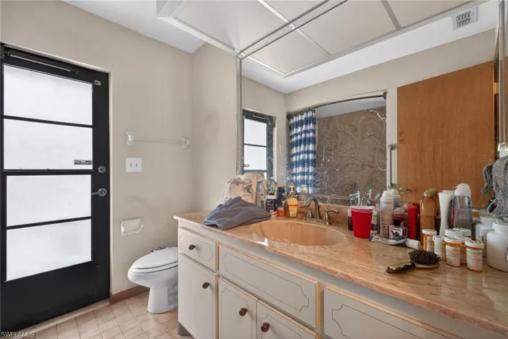 Bathroom with curtained shower and vanity