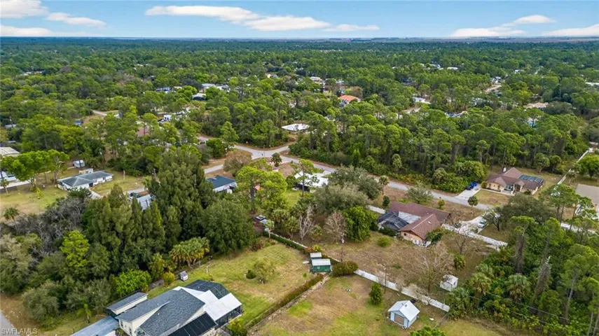 Aerial view of residential area featuring a forest