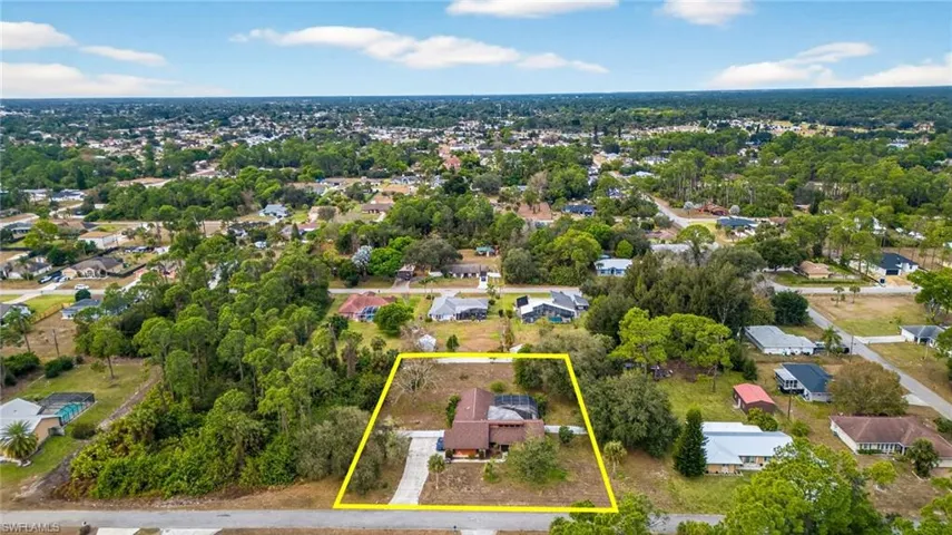 Aerial view of residential area featuring property boundaries highlighted