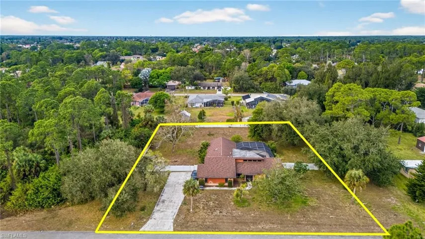 Aerial view of residential area featuring property boundaries highlighted