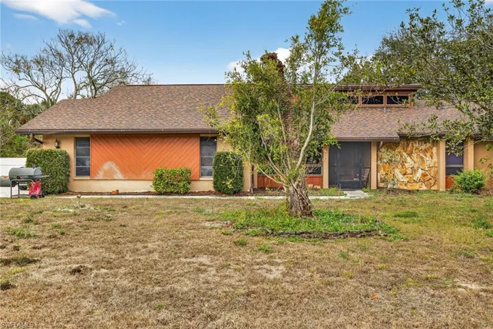 Mid-century inspired home with roof with shingles and a front lawn
