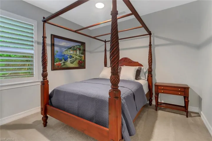 Bedroom with light colored carpet