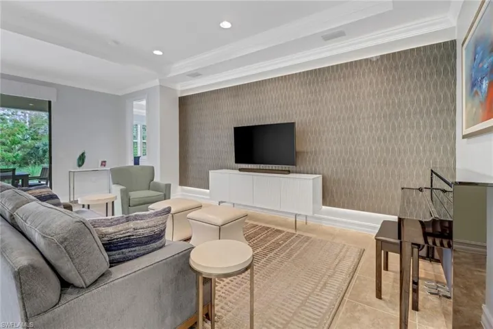 Living room featuring ornamental molding and light tile patterned floors