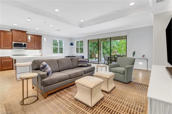 Tiled living room featuring crown molding and sink