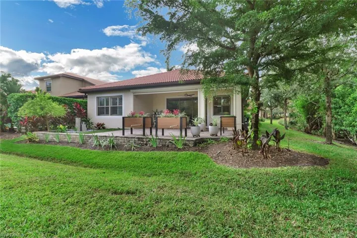 Back of house with a yard, an outdoor living space, and a patio area