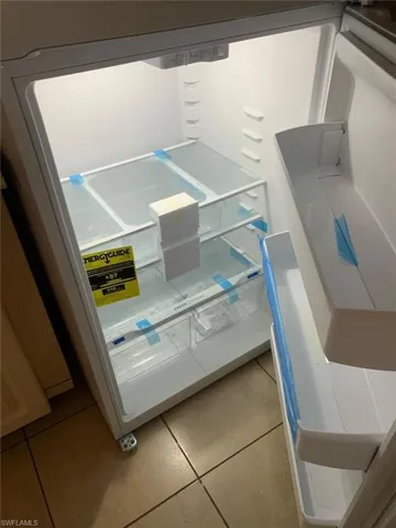 Kitchen view of white refrigerator