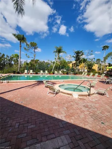 Community pool featuring a hot tub and a patio area