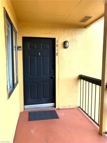 Entrance to property with stucco siding