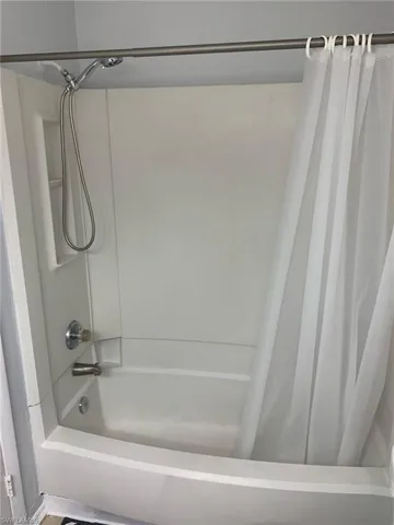 Full bath featuring shower / bath combination with curtain