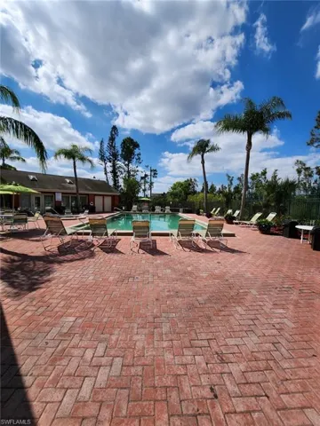 Community pool featuring a patio