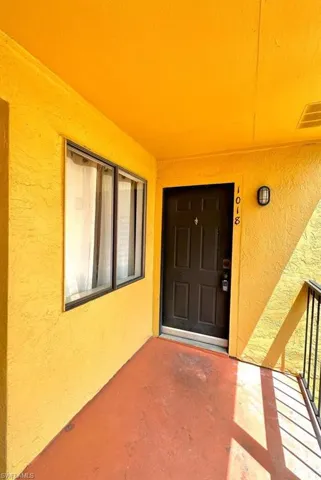 Entrance to property with stucco siding