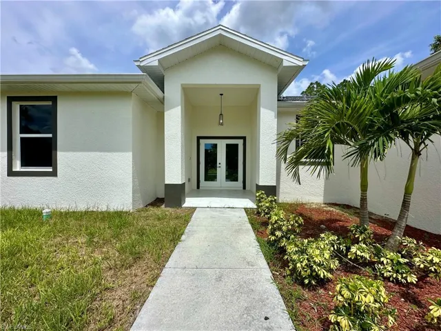 Entrance to property with french doors and stucco siding
