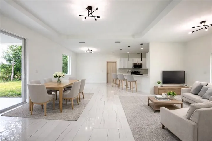 Dining space featuring a raised ceiling and baseboards