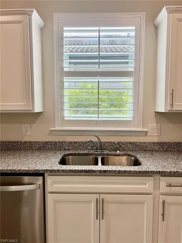 Kitchen window with pretty shutters.