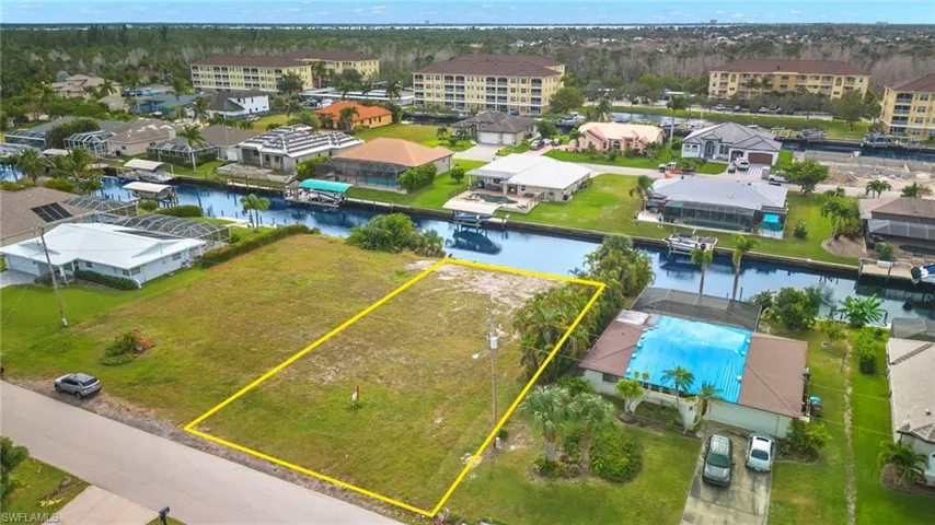 Aerial view of property's location with property parcel outlined and a nearby body of water