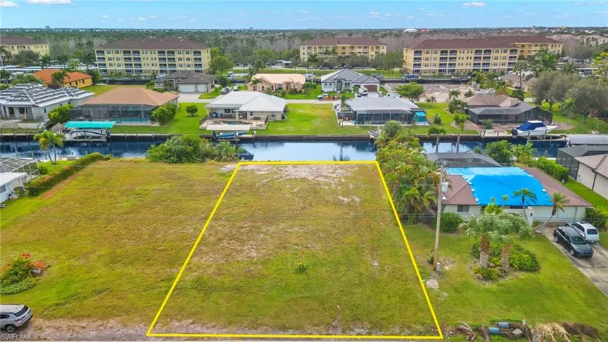 Aerial overview of property's location featuring property boundaries highlighted and a nearby body of water
