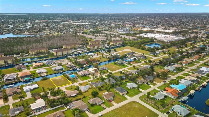 View of property location with a nearby body of water and nearby suburban area
