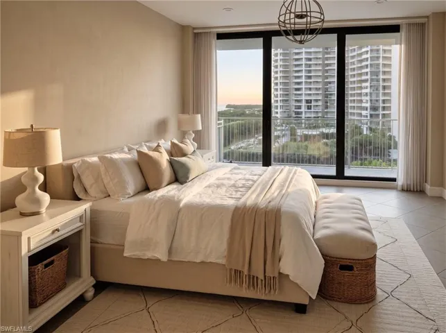 Floor-to-ceiling windows featuring black framing, private balcony access, tile flooring, recessed lighting, and a spherical metal chandelier. virtually staged