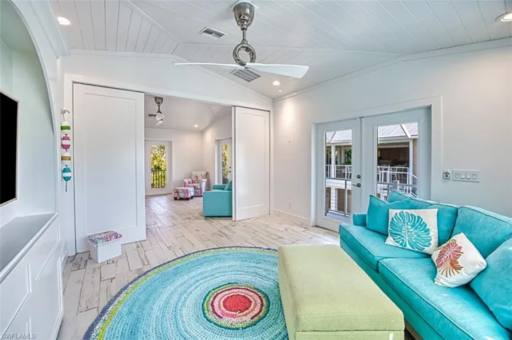 Living area with french doors, vaulted ceiling, wood finish floors, recessed lighting, and wooden ceiling