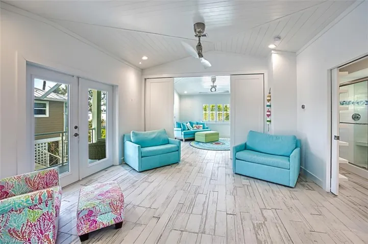 Sitting room with french doors, light wood-style floors, vaulted ceiling, and wood ceiling