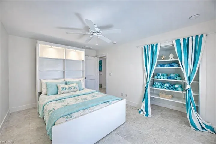 VIRTUALLY  STAGED Bedroom featuring a ceiling fan and baseboards
