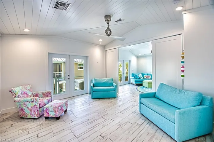 Sitting room with french doors, vaulted ceiling, recessed lighting, wood tiled floors, and a ceiling fan