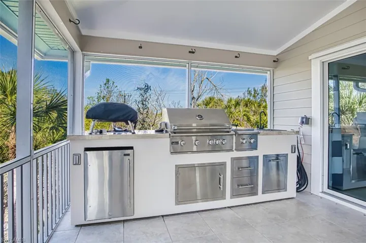 View of patio / terrace with exterior kitchen and a sink