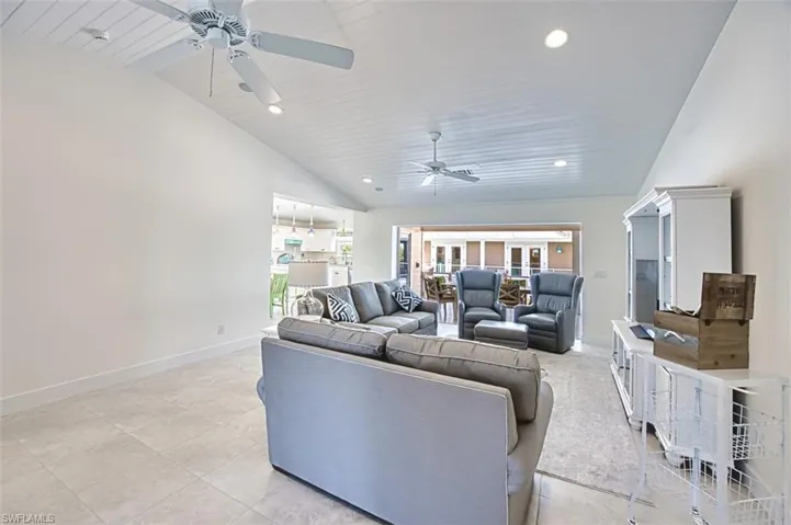 Living area featuring recessed lighting, light tile patterned floors, wood ceiling, high vaulted ceiling, and a ceiling fan