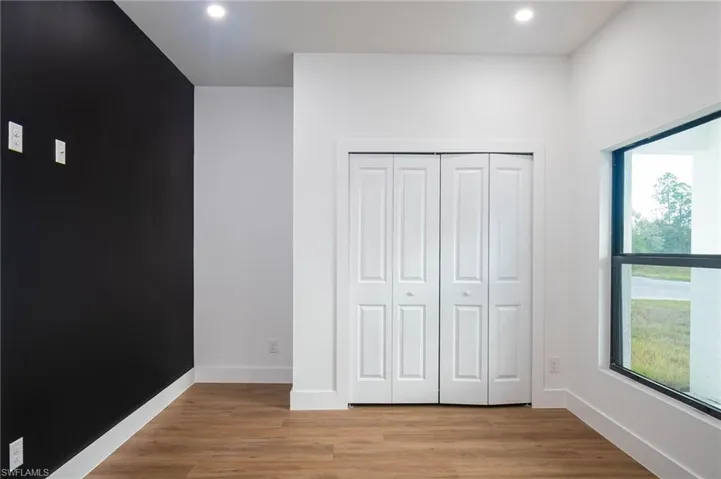 Unfurnished bedroom with a closet and light hardwood / wood-style floors