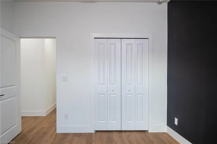 Unfurnished bedroom featuring hardwood / wood-style floors and a closet