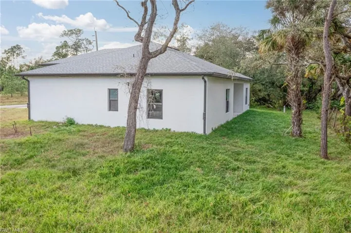 View of side of property featuring a lawn