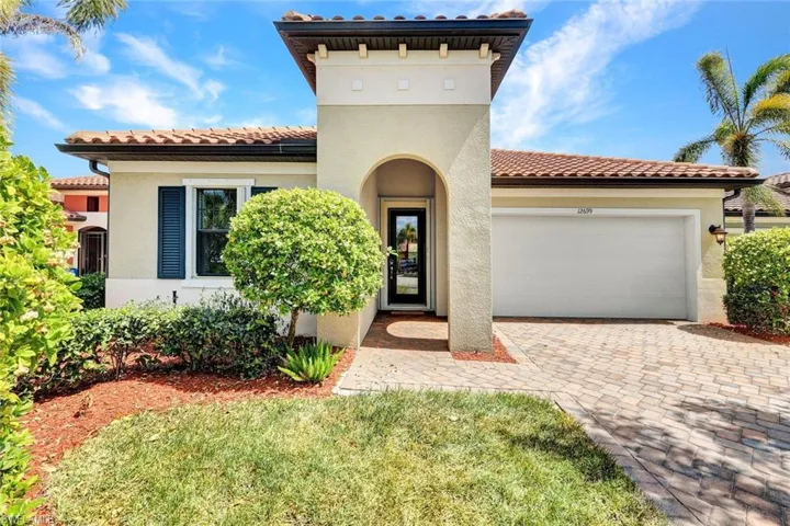Mediterranean / spanish-style house with a garage, stucco siding, a tile roof, and driveway