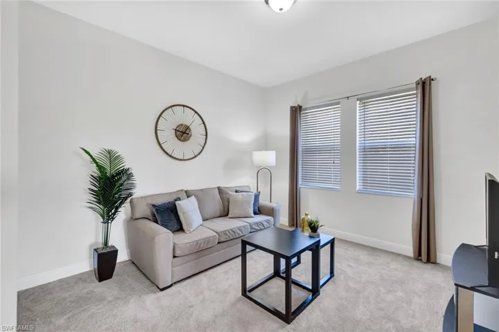 Living room featuring light colored carpet and baseboards