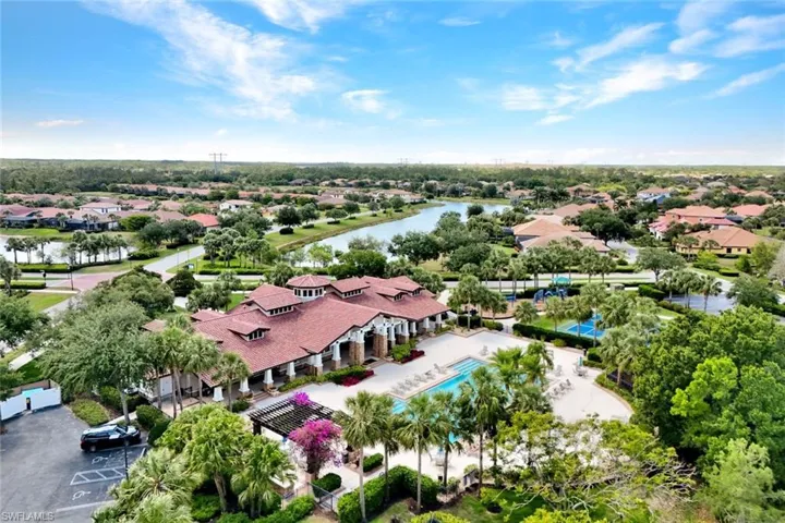 Aerial perspective of suburban area featuring a large body of water and a pool