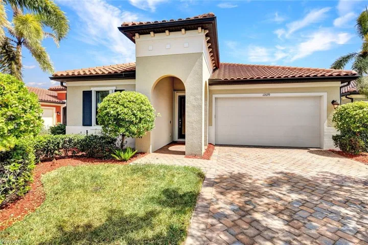 Mediterranean / spanish house with stucco siding, a garage, and a tile roof