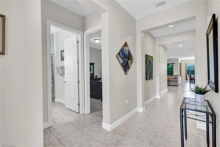 Hallway with light tile patterned floors and baseboards
