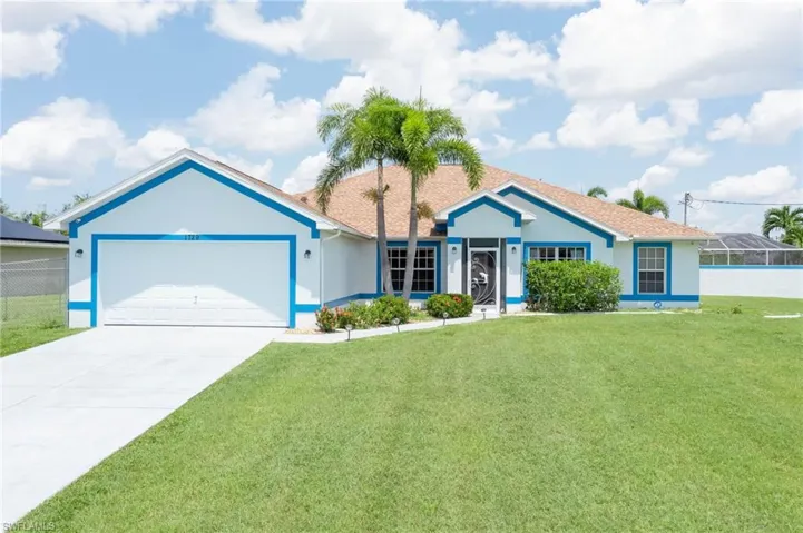 Single story home featuring stucco siding, a front yard, driveway, and a garage