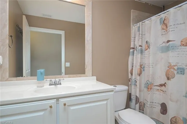 Full bathroom featuring vanity and a shower with shower curtain