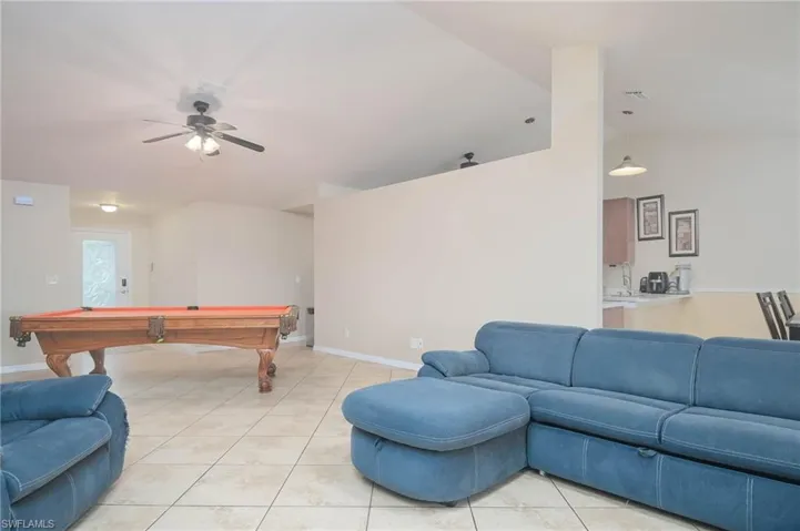 Rec room featuring pool table, ceiling fan, light tile patterned floors, and lofted ceiling