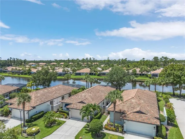 Birds eye view of property with a water view