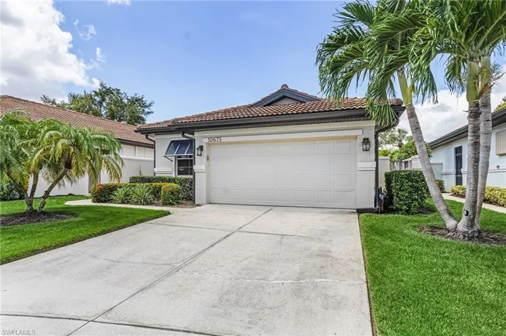 Mediterranean / spanish-style house featuring a garage and a front lawn
