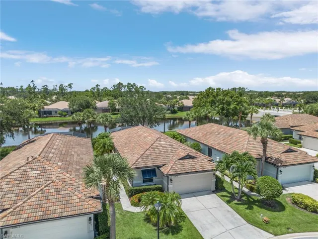 Birds eye view of property with a water view