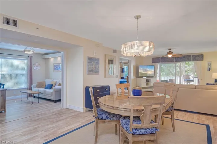 Dining space with light wood-type flooring and ceiling fan
