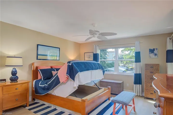 Bedroom featuring light hardwood / wood-style flooring, radiator, and ceiling fan